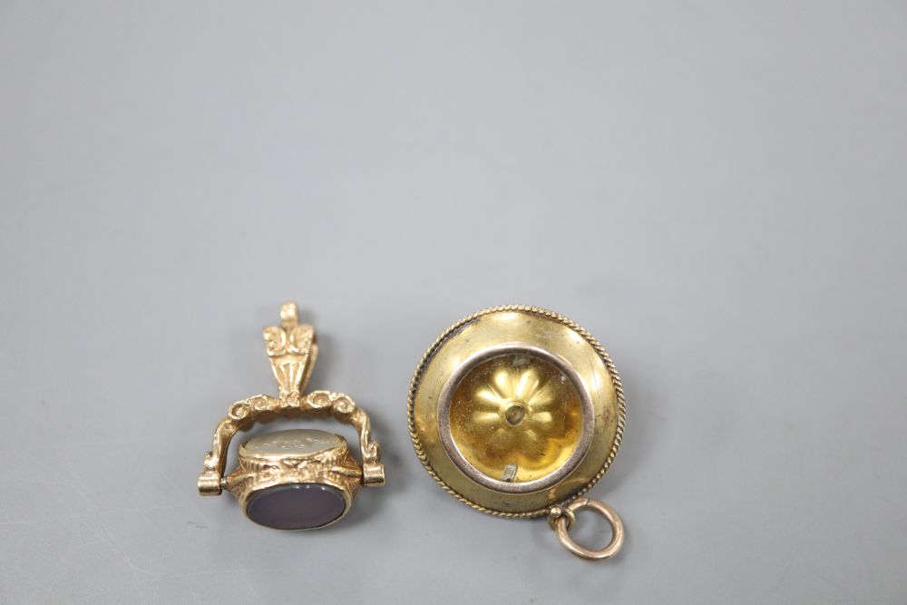 A Victorian yellow metal and cabochon amethyst set pendant, 20mm and a modern 9ct gold and gem set fob, gross 8.6 grams.